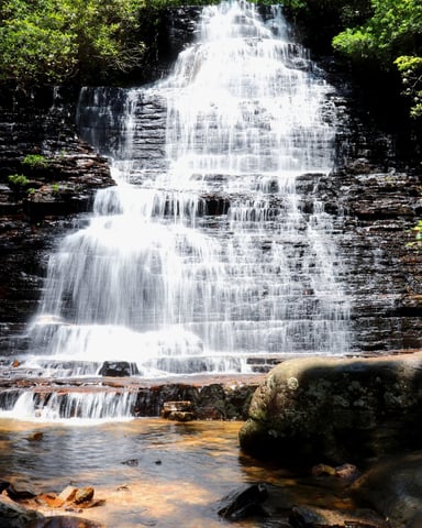 Waterfall cascading over layered rocks in the Ocoee region