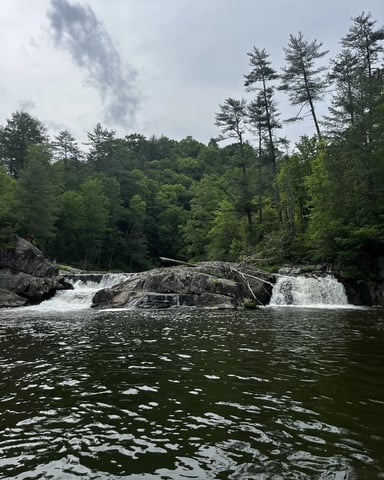 Wide river rapids and pine trees at Center Hill Lake